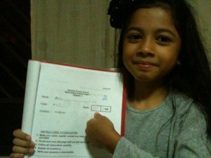 Amira proudly showing her full marks for Maths